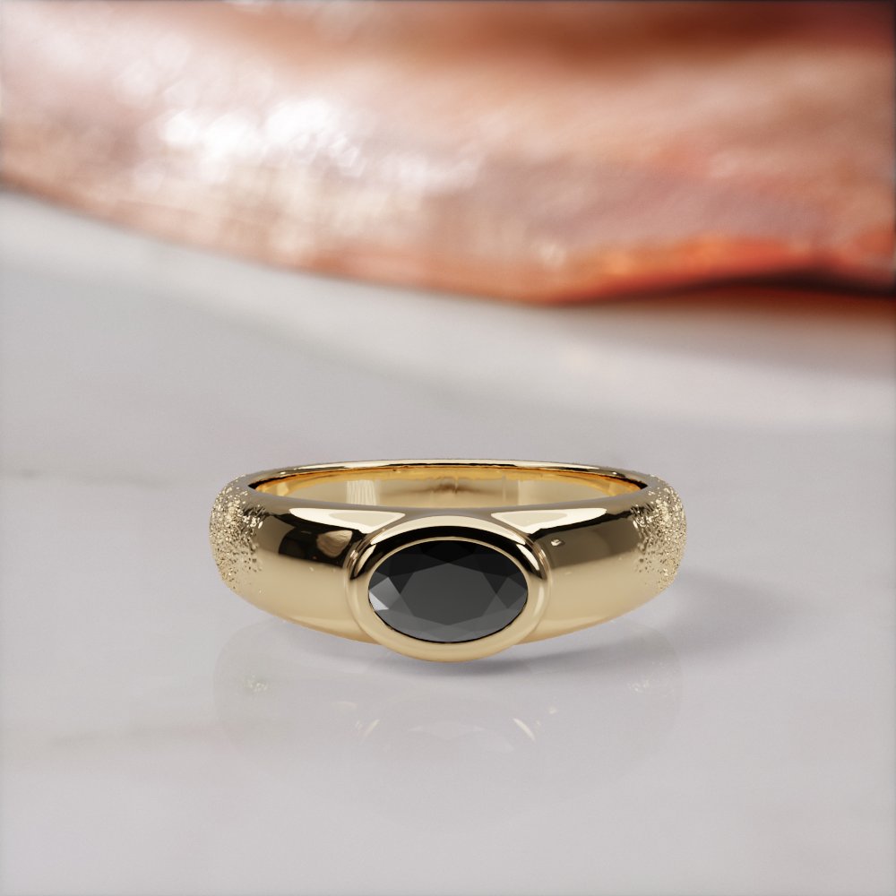 Smoothen engagement ring in yellow gold, front view of a bezel-set black diamond sunk into a smooth, pebble-like band