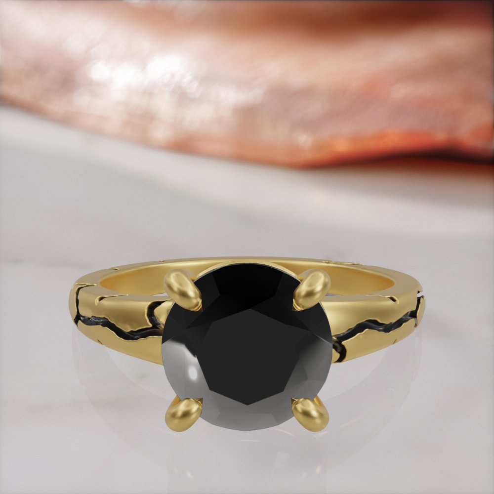 Kintsugi engagement ring in yellow gold, front view of the round black diamond held by four claw prongs
